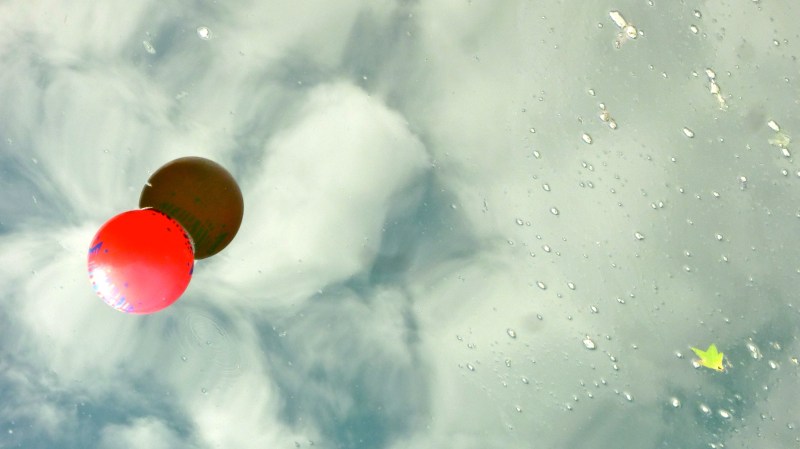 Making Mirrors Red ball on reflective water, cloud reflections