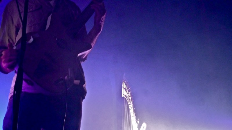 Close up on Barr Brothers' guitar and harp