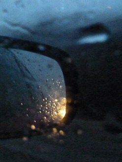 Car side view mirror moving in rain