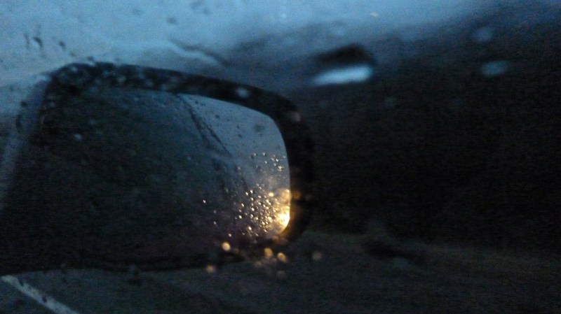 Car side view mirror moving in rain