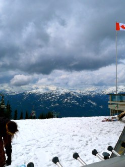 Snowboarder on to of Blackcomb Mountain, Whistler BC, Canada flag