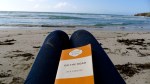 reading on an Australian beach, sunset